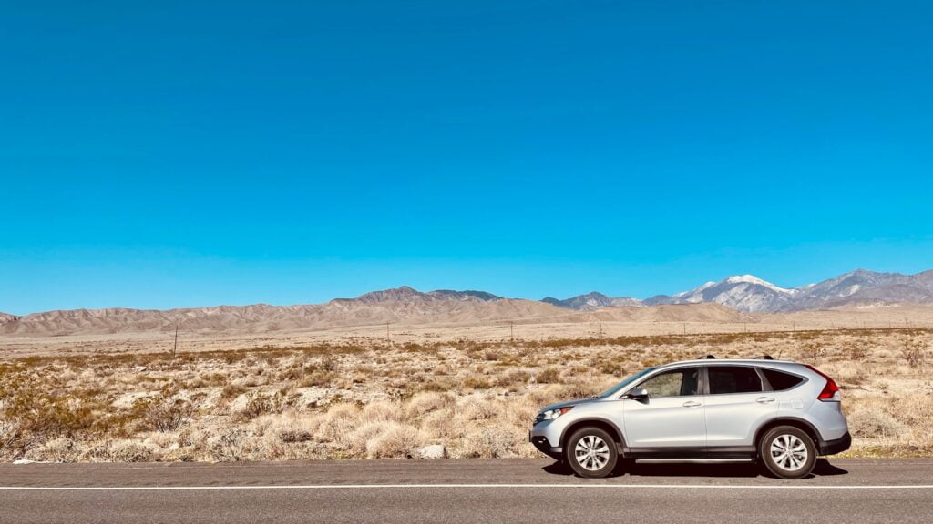 silver sedan on road during daytime